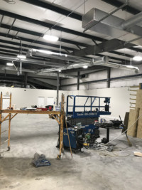 Ductwork installation in progress for fabrication shop
